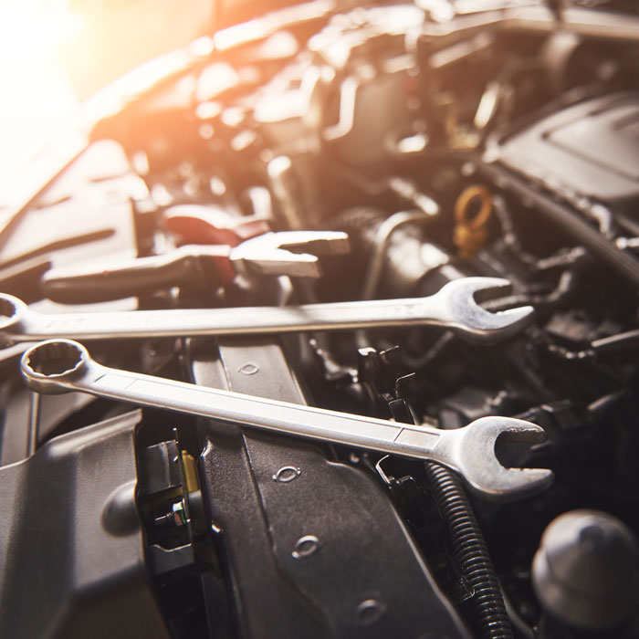 wrench laying on top of car engine